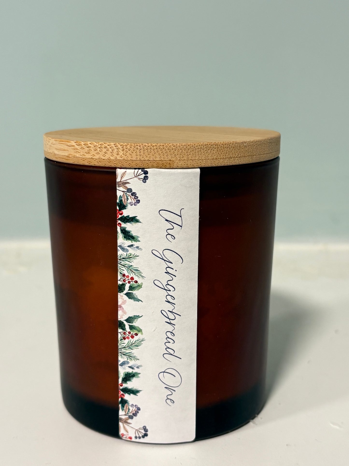 Gingerbread candle with crackling wood wick in amber jar
Hand-poured gingerbread soy candle with boho botanical label
Wood wick Christmas candle with warm spiced fragrance
Gingerbread scented candle styled with festive decor