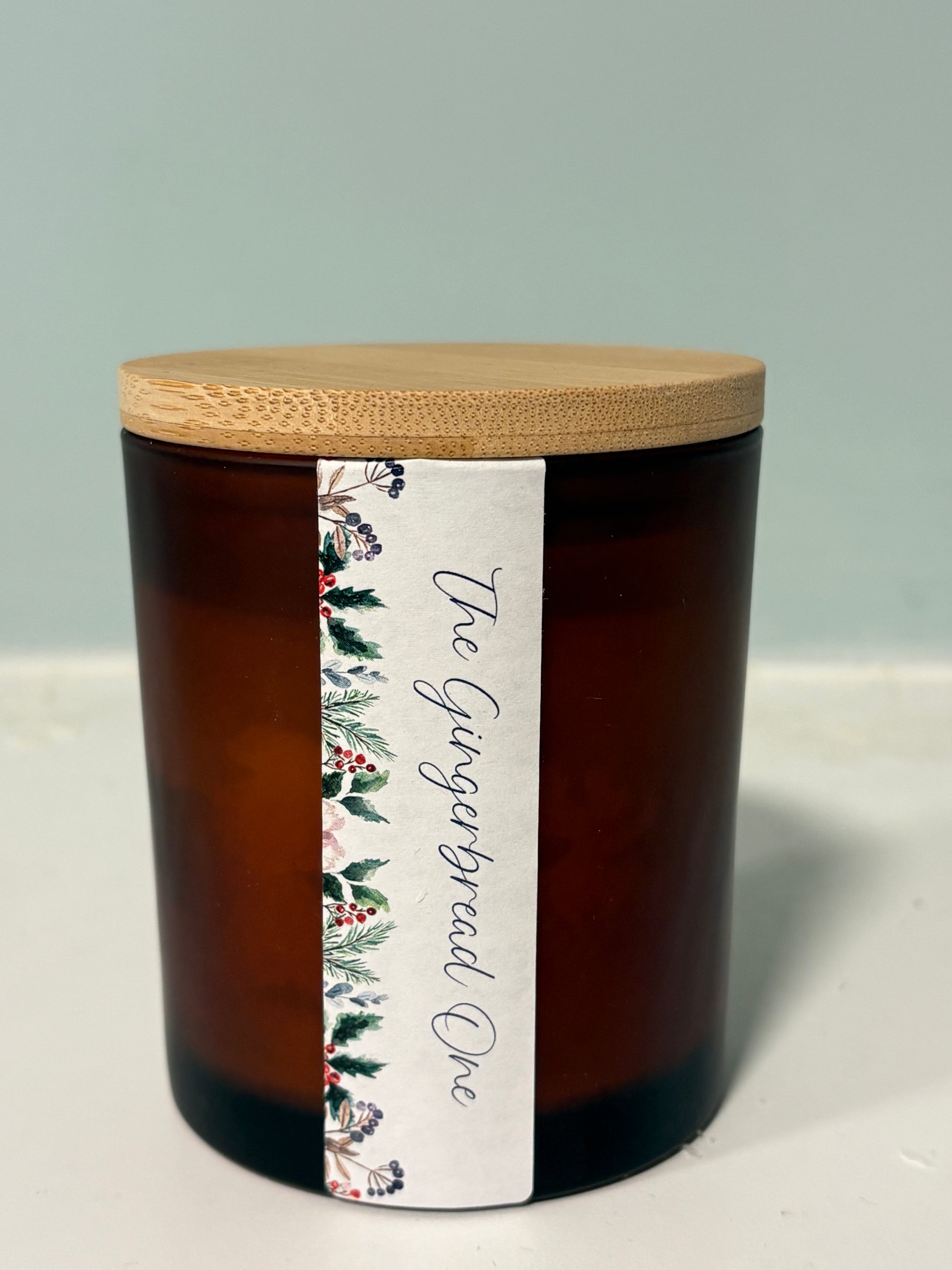 Gingerbread candle with crackling wood wick in amber jar

Hand-poured gingerbread soy candle with boho botanical label

Wood wick Christmas candle with warm spiced fragrance

Gingerbread scented candle styled with festive decor